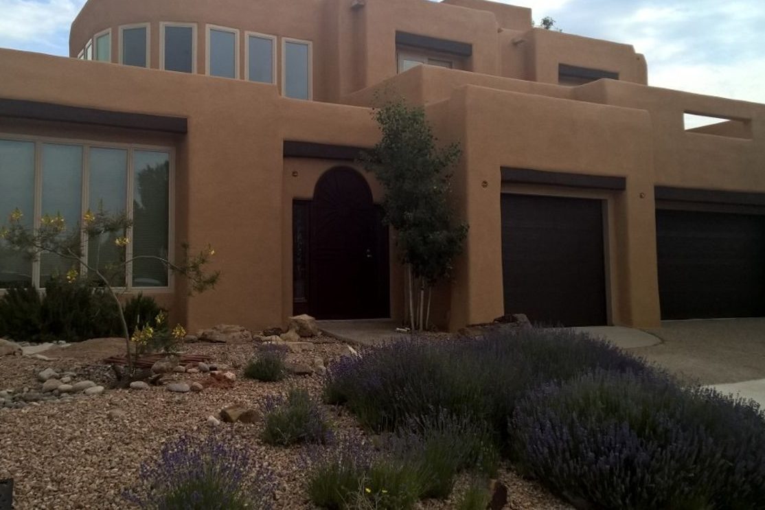 Two-story Pueblo-style home with a synthetic stucco finish over spray foam walls