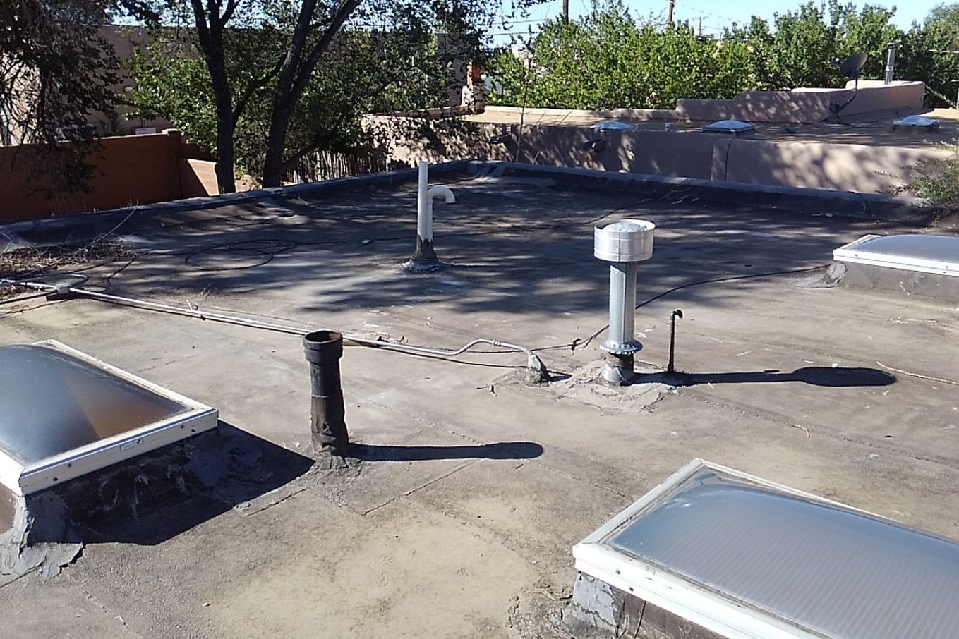Flat spray foam roof with skylights on a Santa Fe casita